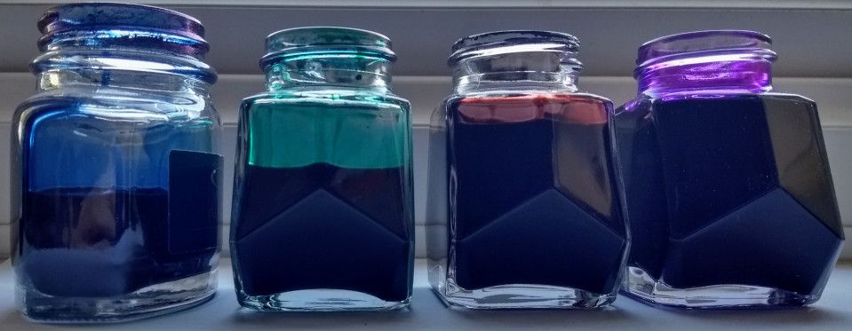 Four of my bottles of ink, blue black, green, brown and purple.