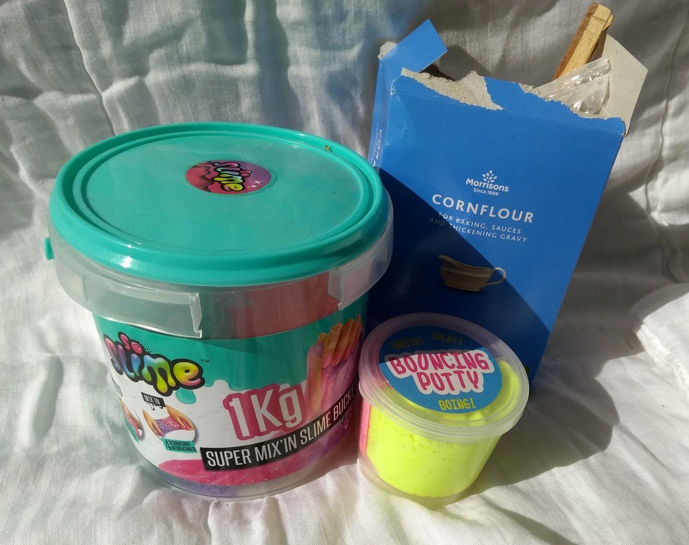 A 1KG tub of slime, a small pot of "bouncing putty" and a box of cornflour.