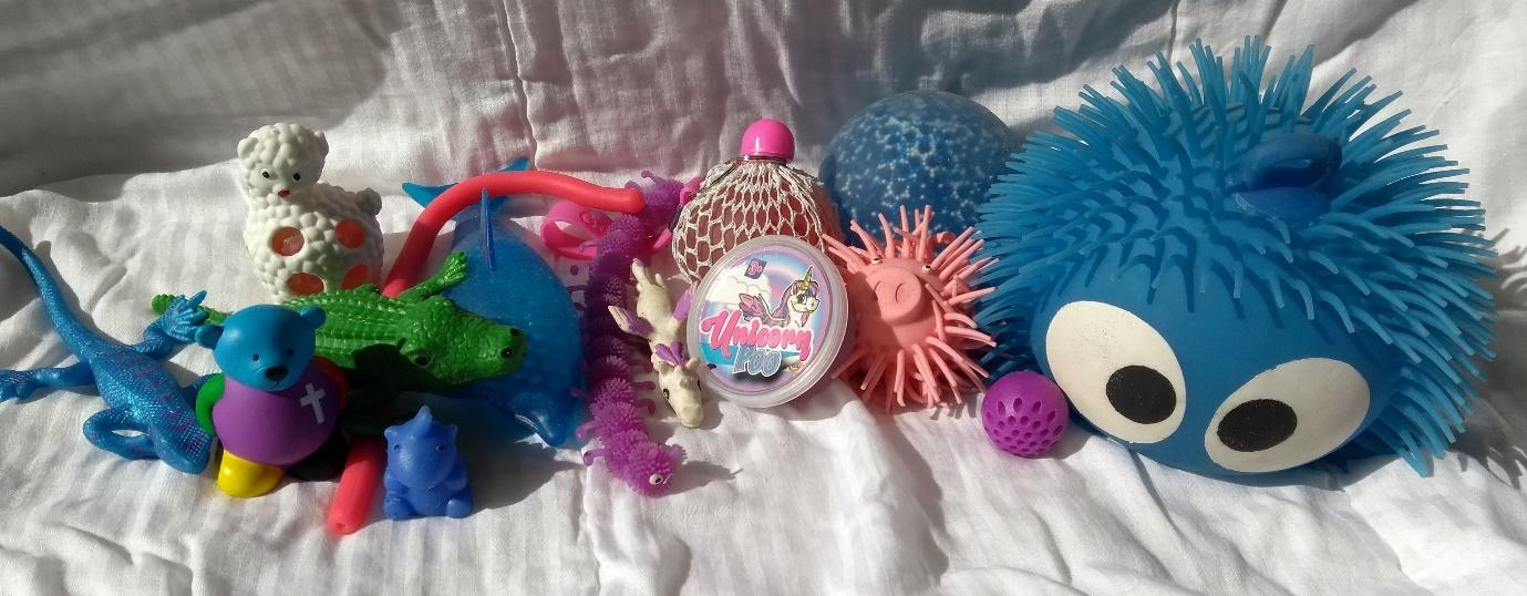 Various squishy toys including "unicorn poo" slime and stress balls.