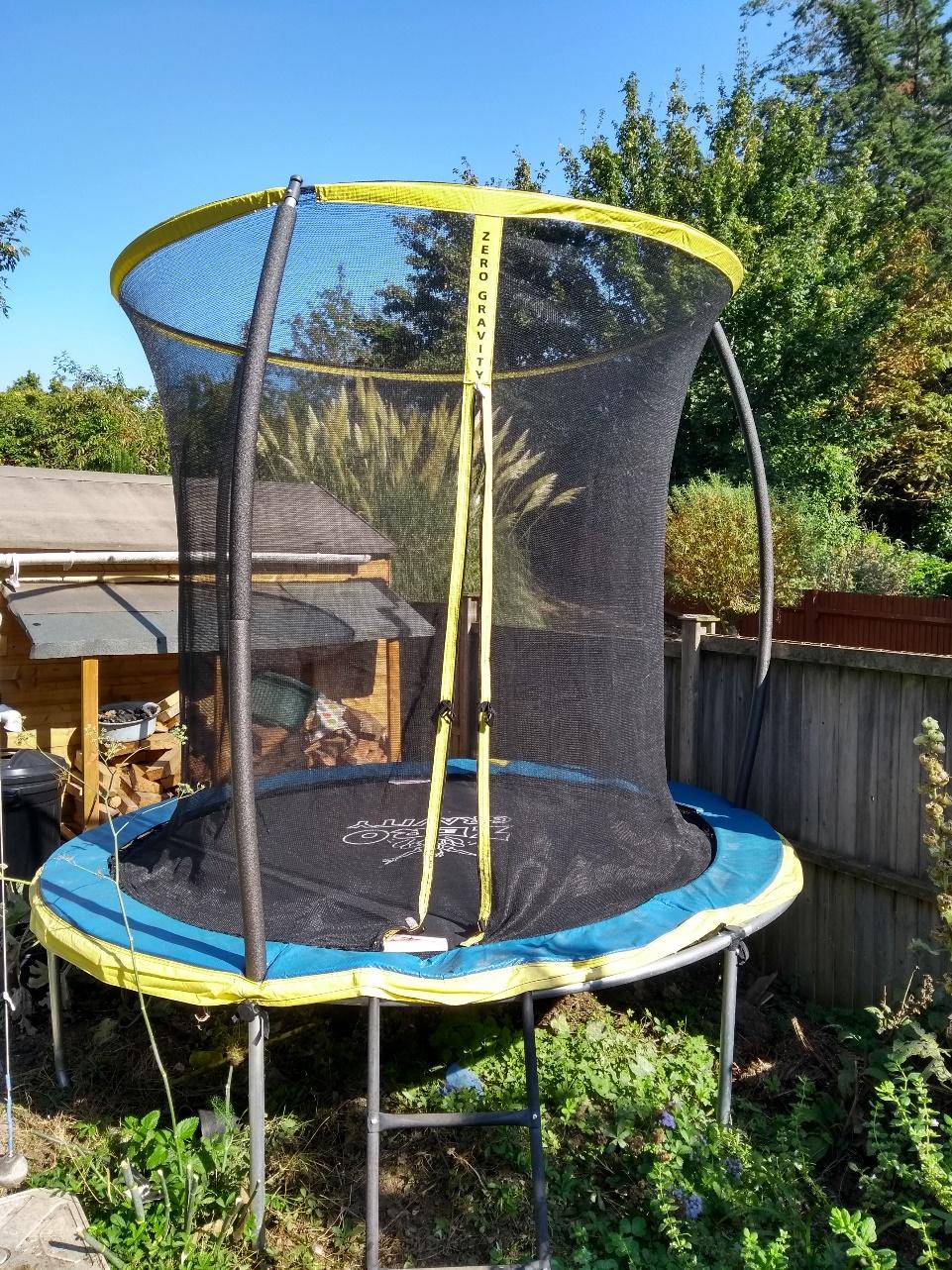 Trampoline in a back garden.