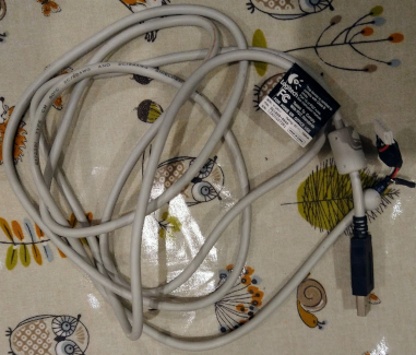 Pale grey USB cable, messily coiled.