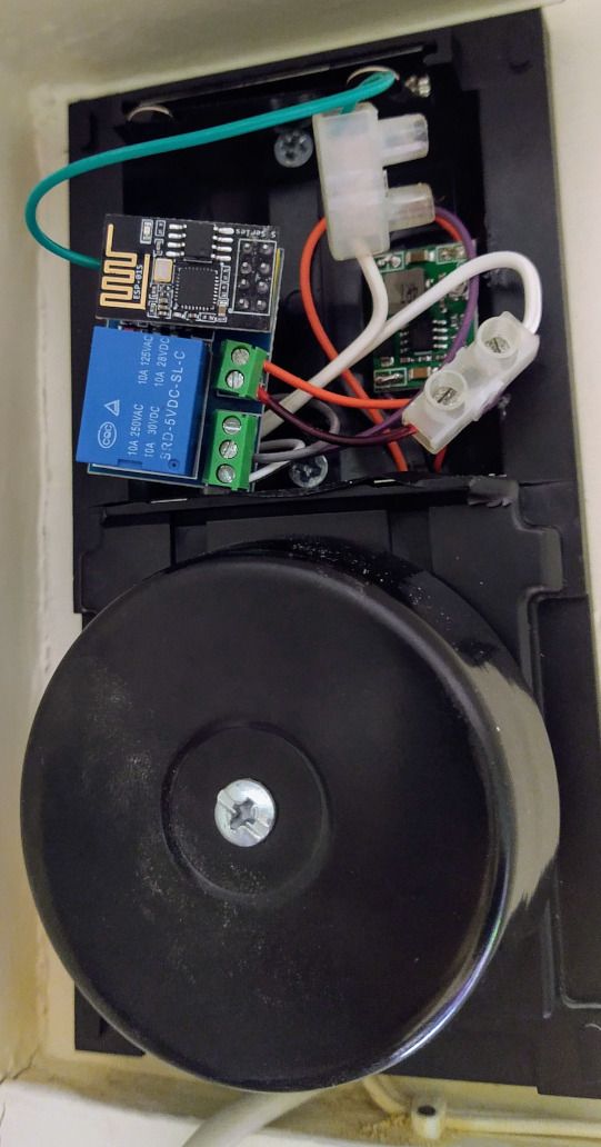Two circuit boards inside the doorbell enclosure, where the batteries once were.  Towards the bottom is the bell itself.