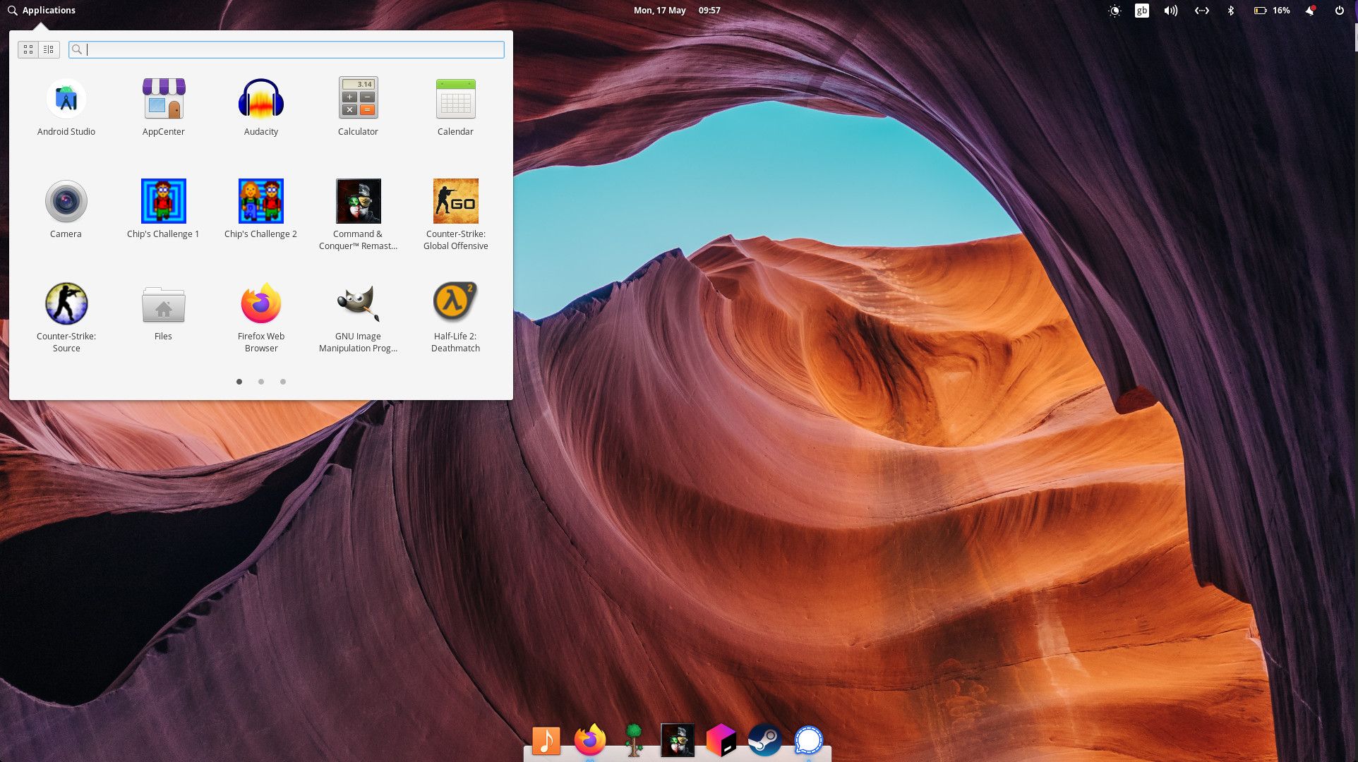 Screenshot of the Pantheon desktop, showing the applications menu open in the top right and a dock at the bottom centre.