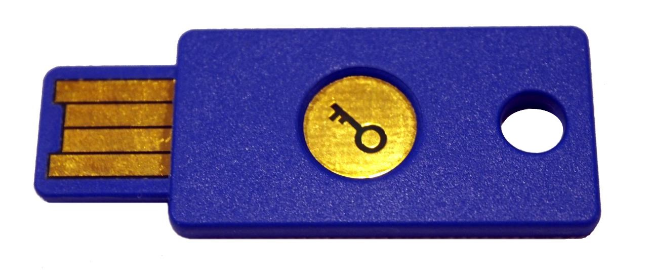 Bright blue, flat, rectangle device with gold metal contacts for plugging into a USB socket. In the middle of the rectangle is a gold circle with a key symbol on it. There's also a hole so the device can be placed on a key chain.