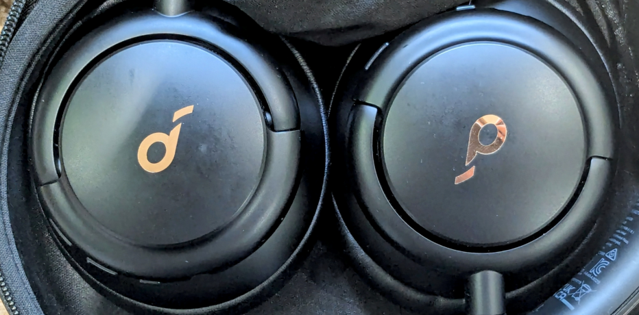 Photograph of the Q30 earphones, packed away, cropped to only show the ear pieces.