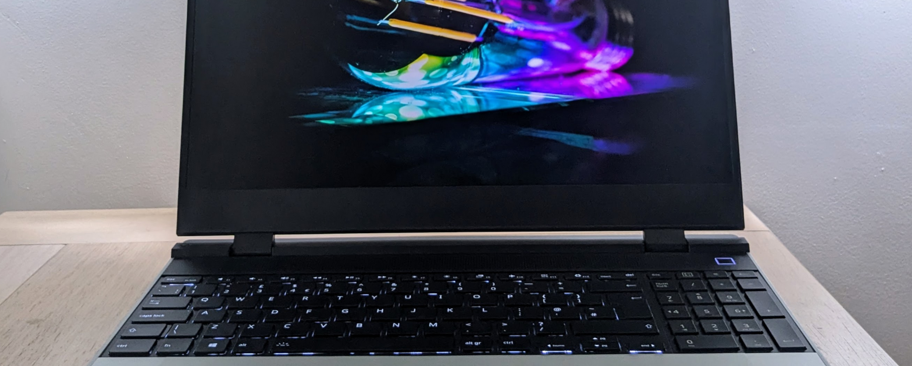 Cropped photo showing part of a laptop screen and part of its keyboard.  The laptop is on.