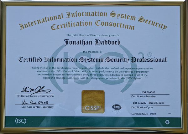 A certificate is in a gold frame with a gold CISSP logo and green (ISC)² accents.